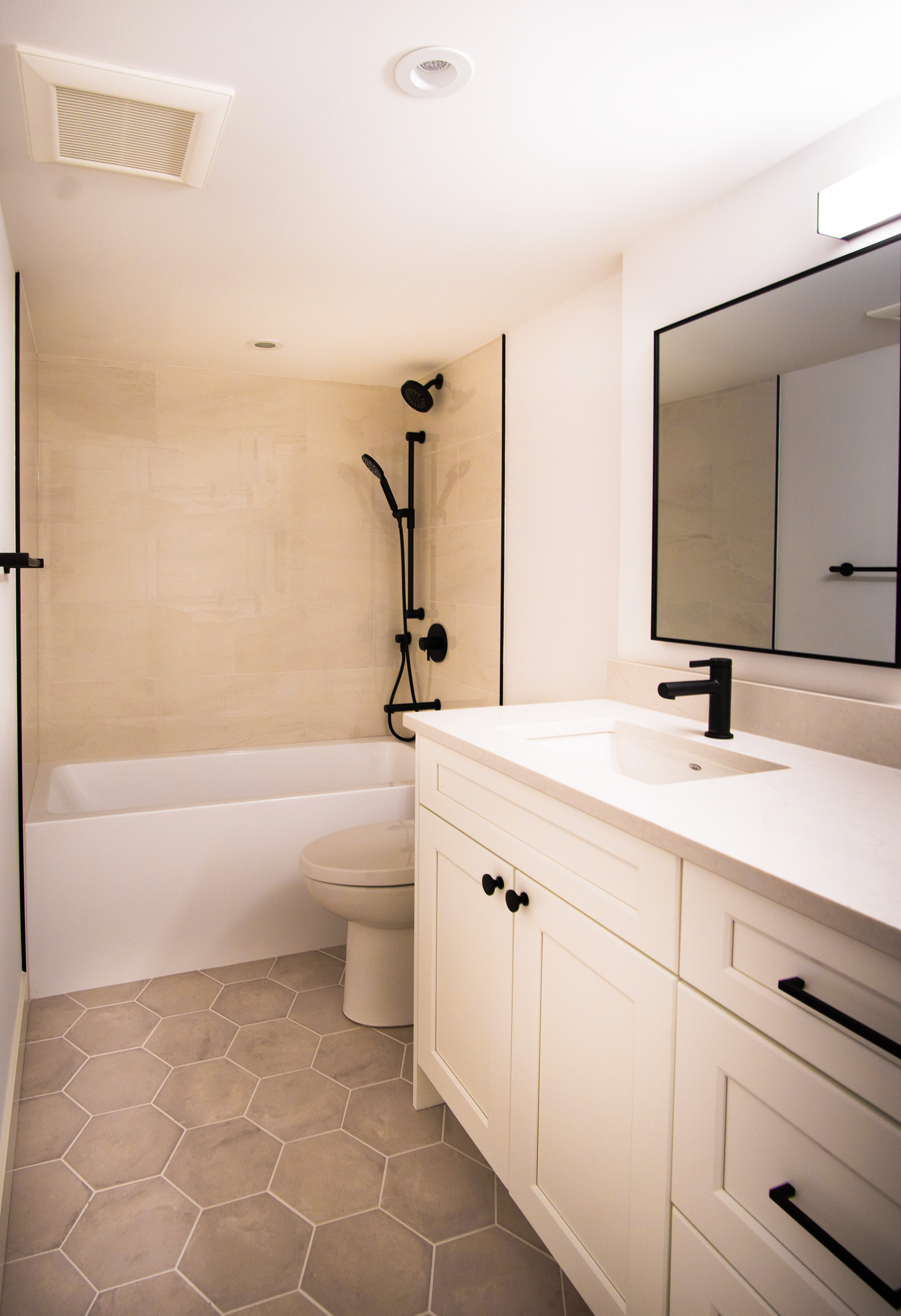 Renovated bathroom with matte black fixtures — Langley